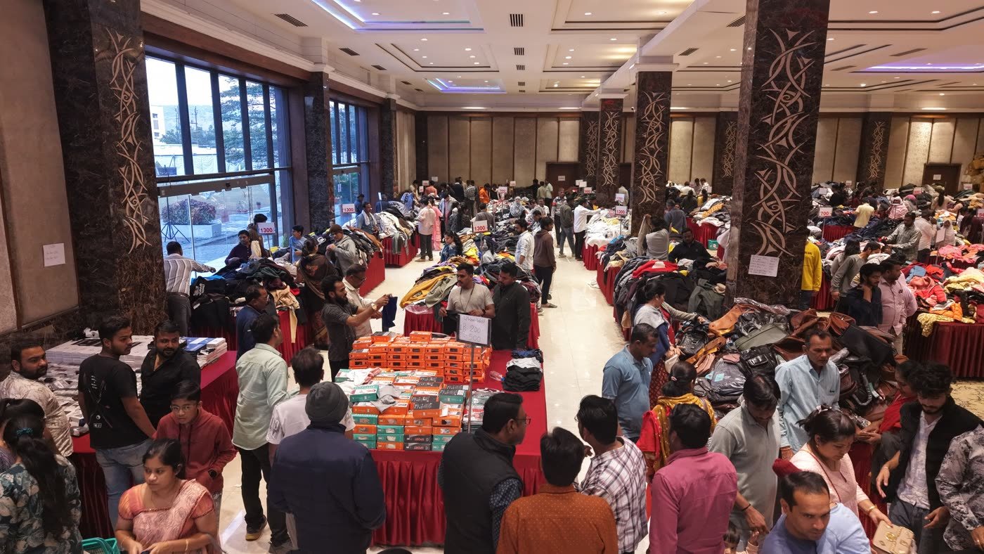 Crowded exhibition hall with visitors browsing stalls